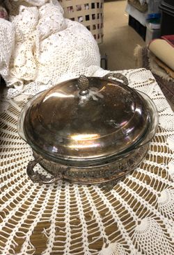 Silver stand and silver cover with glass dish collectible for serving dinner.