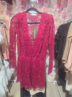 Red Lace Romper with padded shoulders.