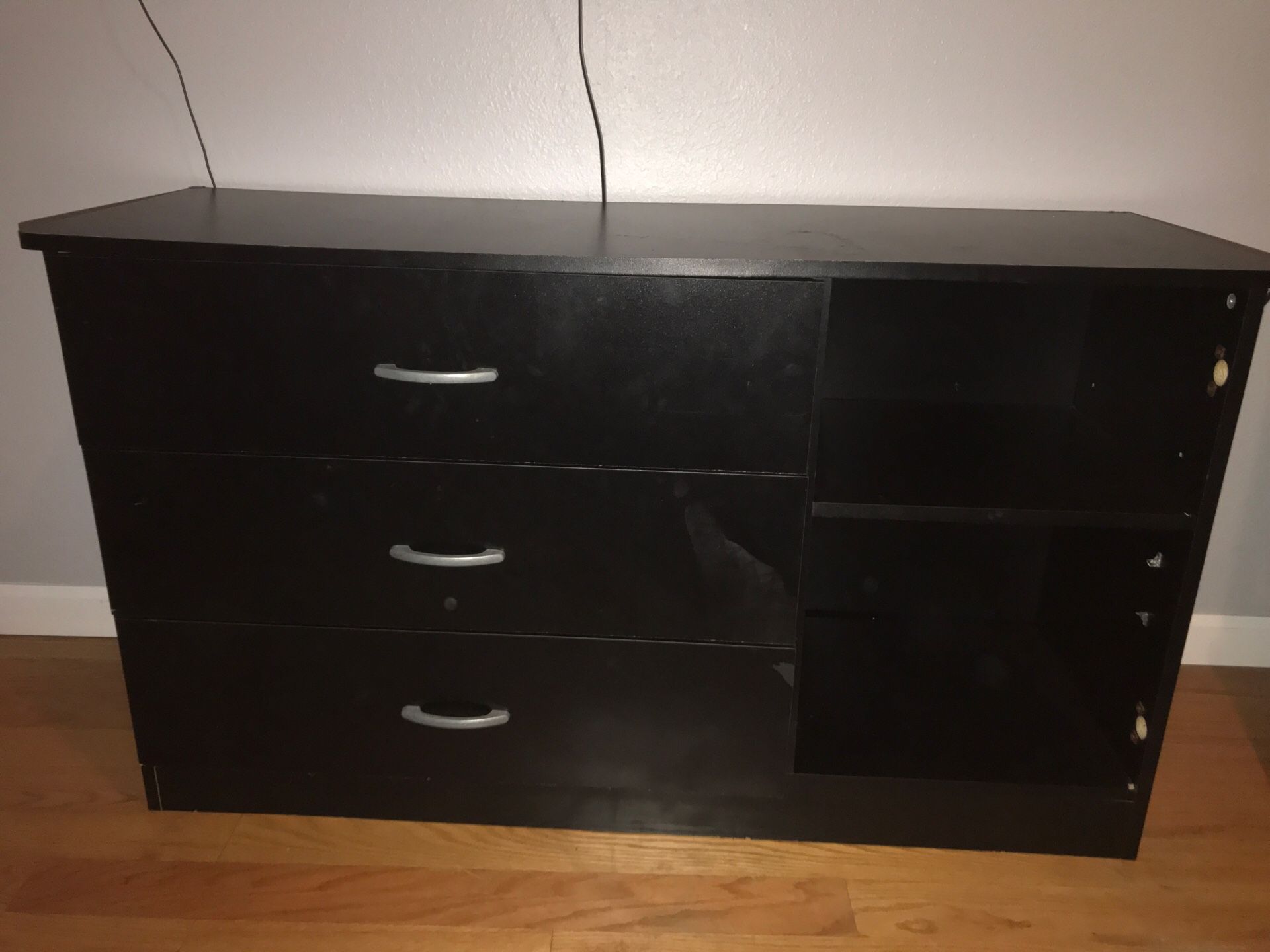 Three drawer black dresser with shelves