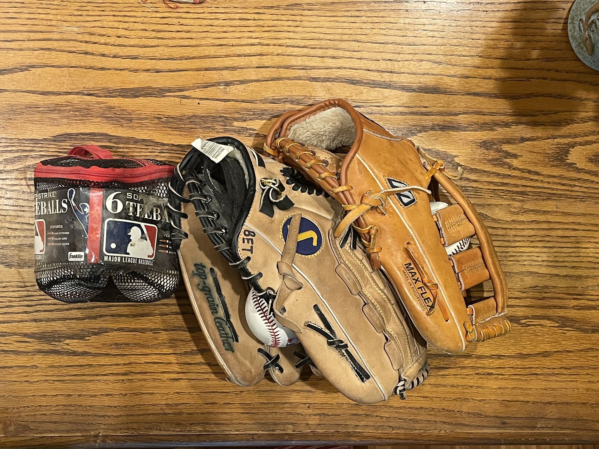 Two Baseball Gloves, One Large, One Medium. Multiple Softball/Baseball Balls Included