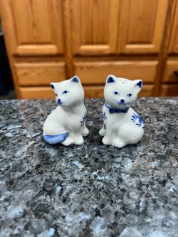 Vintage Porcelain Cat Floral design blue and white pair of salt and pepper shakers.  Size 2 1/2 inches tall.  Preowned good condition.