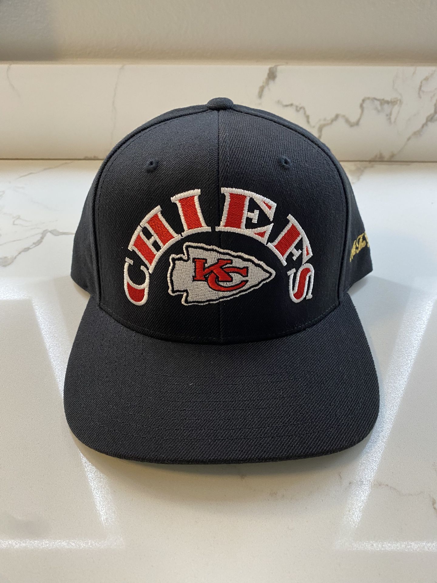Item listed is a brand new, never worn “Kansas City Chiefs” 5-panel snapback by All The Glory.
