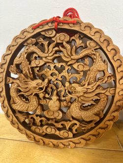 This is a traditional Chinese hand-carved camphor wood wall plaque