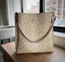 Cream Coach Signature canvas Sophie bucket bag. Like new!! Originally purchased from Coach boutique. #Coach #bucketbag