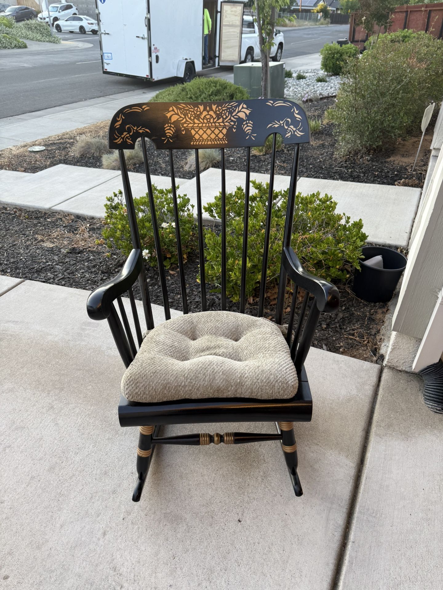 Beautiful solid wood in black and gold accent rocking chair in really good condition!
