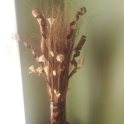Vase with animal print brown cream colors with flower arrangement