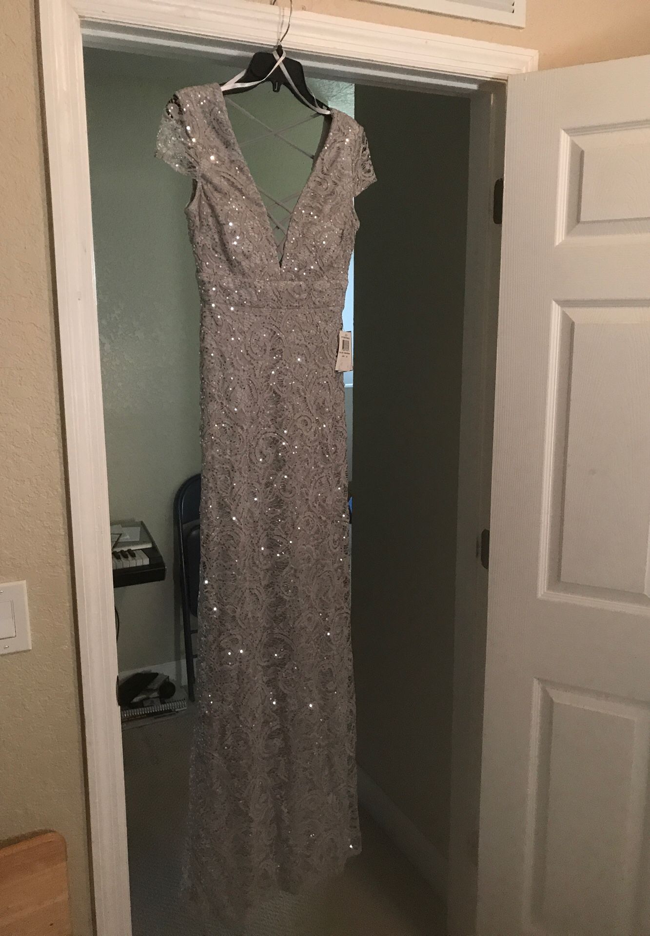 NEED TO SELL ASAP: Brand new silver dress size 3/4. Never Worn