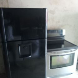 A Black And Stainless Stove Refrigerator