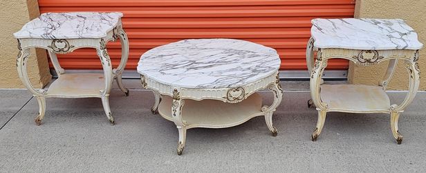 Vintage white marble top French provincial coffee table features intricate gold gilded accents and elegant cabriole legs.
