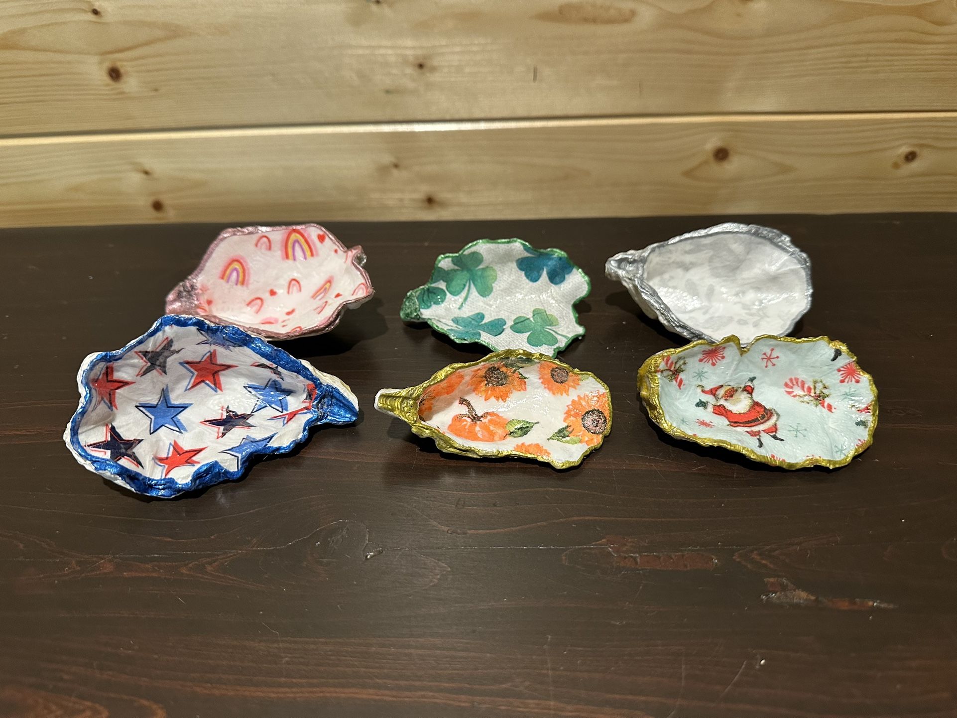 Handmade decoupage catch all concave shells in seasonal holiday themes.