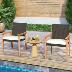 Two Outdoor Dining Chairs With White Cushions