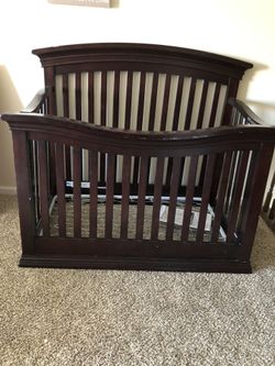 Brown baby crib, mattress and bedding included
