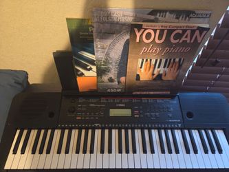 Yamaha keyboard stand and books