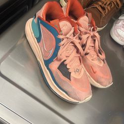 These sneakers are the Nike Kyrie Low 5 in the "Light Madder Root" colorway