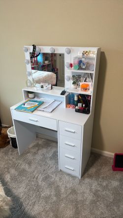 Vanity/desk with mirror and working lights.