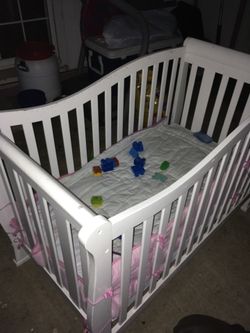 White baby crib can turn into a bed come with mattress