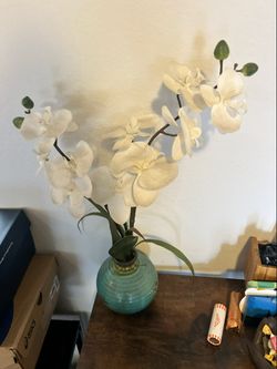 Faux white orchid in turquoise decorative pot