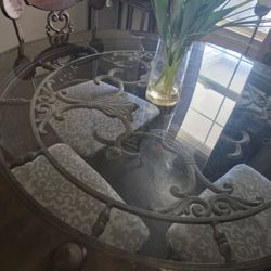 Metal table frame seats for people glass top no cracks no damages. Chairs are in decent condition. Comes with all four chairs moving need to sell ASAP