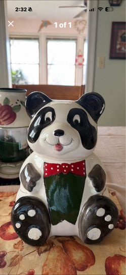 This is a hand-painted ceramic panda bear cookie jar.