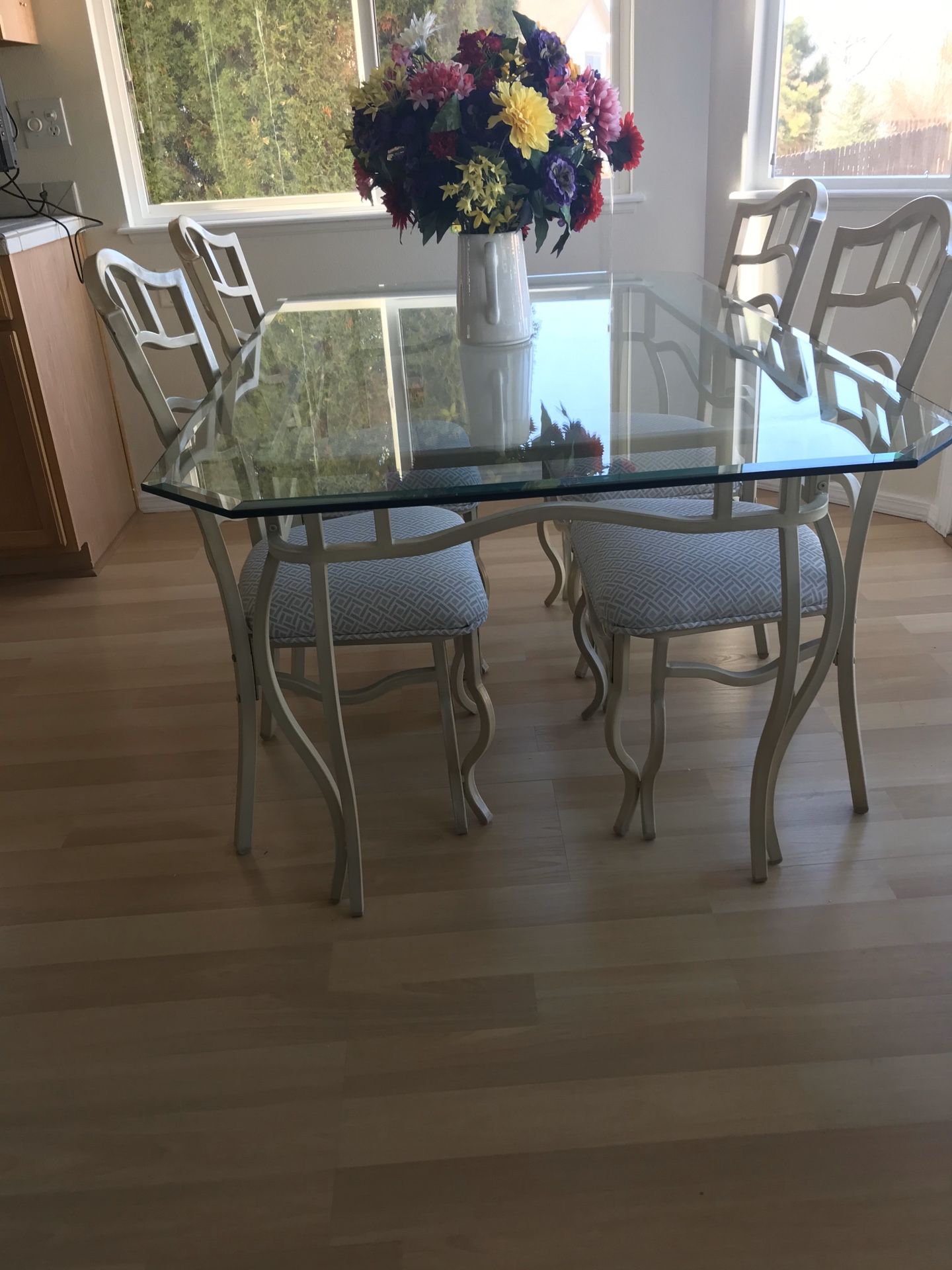 Beveled glass table with metal frame and chairs.