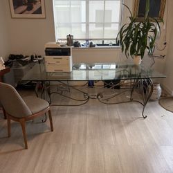 80” x 40” glass top table with decorative cast iron base