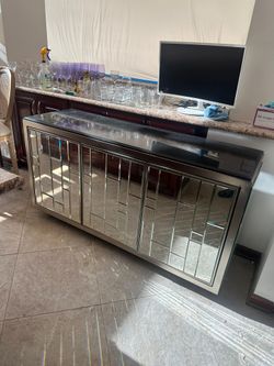 Midcentury modern chrome and mirrored glass credenza with a black granite top