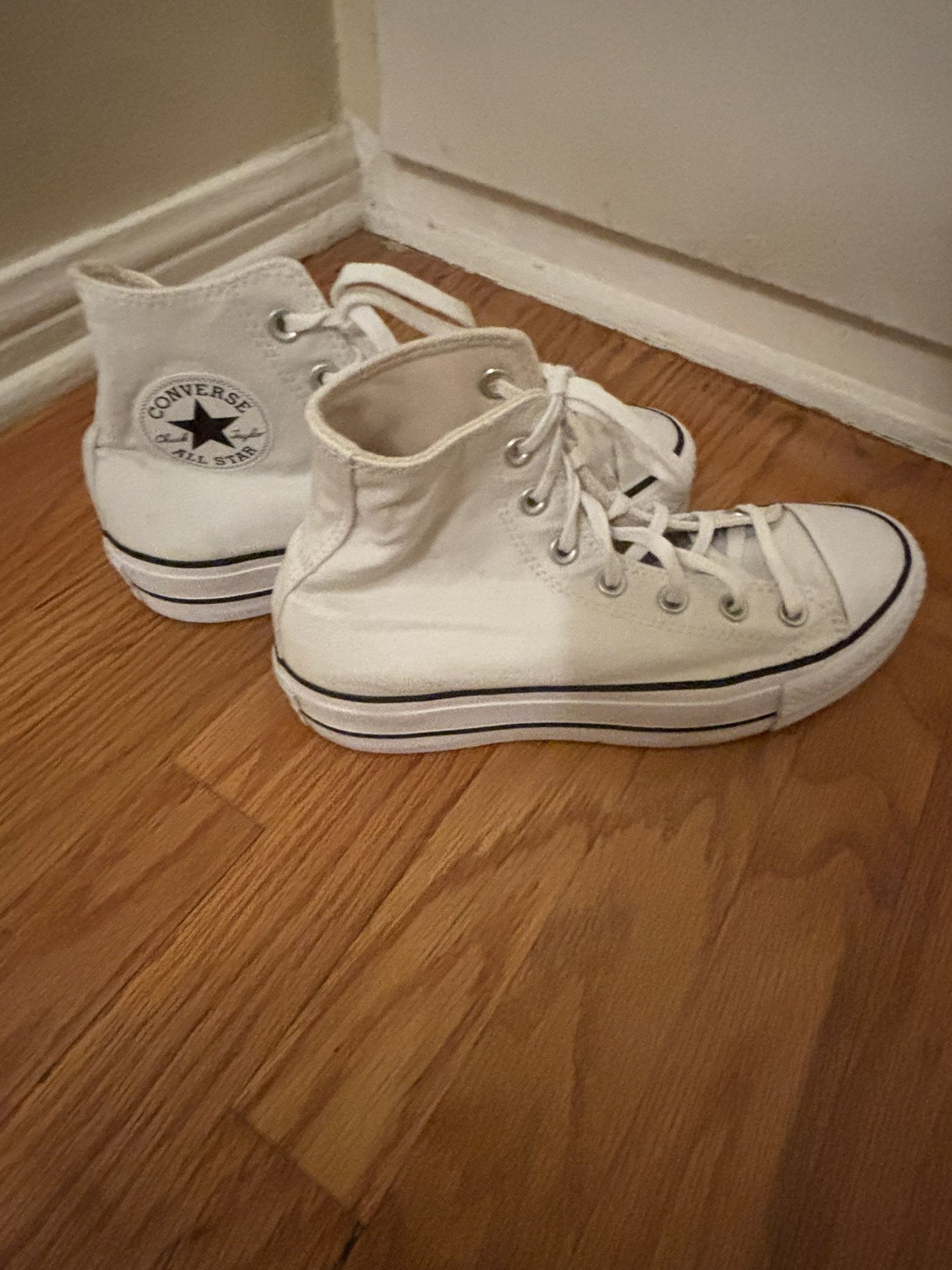 White Chuck Taylor High Tops.