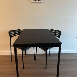 Ikea Black Wood Dining table & Plastic Chairs