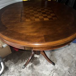 Cherry wood round game table with a chessboard inlay