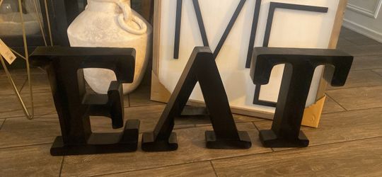 Metal “EAT” wall letters