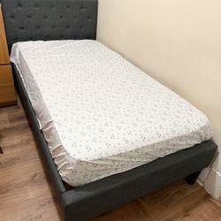 Single Bed Frame – Grey Fabric – $80  Gently used single bed frame in excellent condition. Grey fabric upholstered frame with a sturdy wooden slat mat