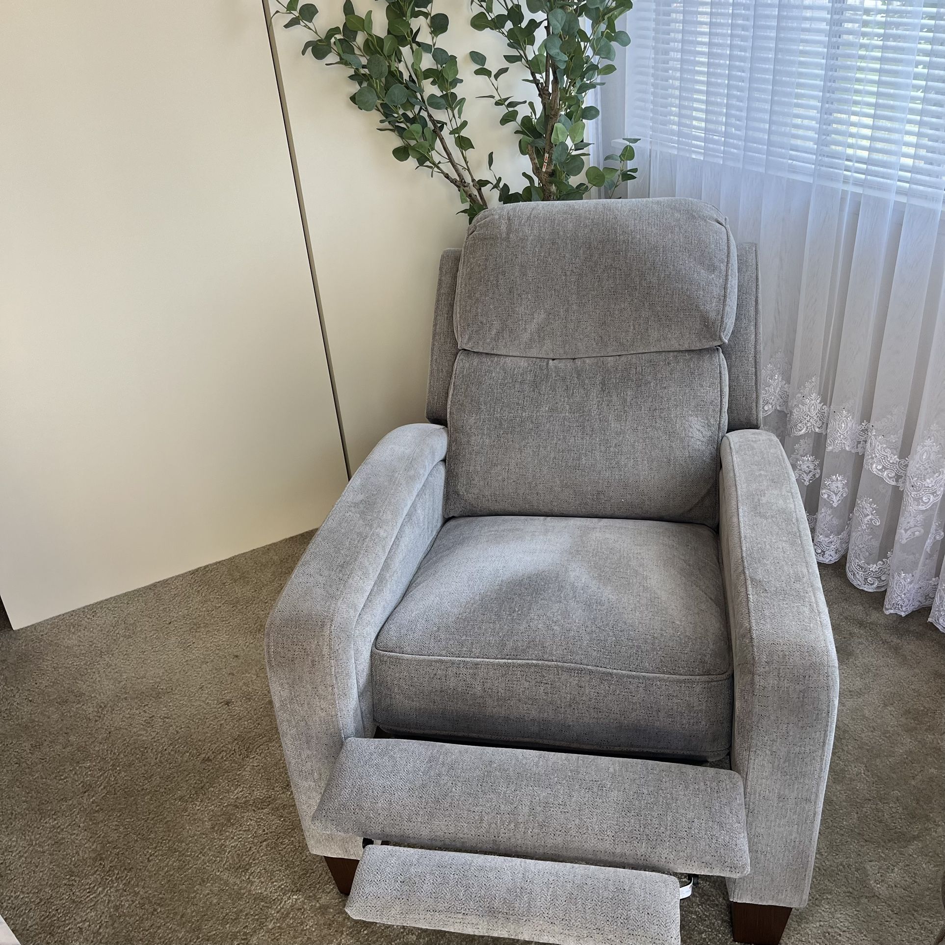 Fabric Pushback Recliner chair with removable sides on the back.