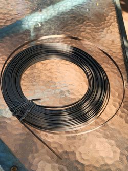 Coil of 1/4" steel strapping (also known as metal banding), which is a high-tensile material used for securing heavy packages, crates, and palletized