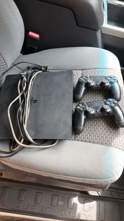 PlayStation 4 with two controllers