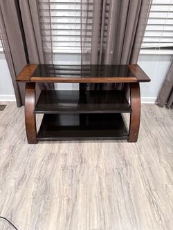 Dark wood and glass tv stand