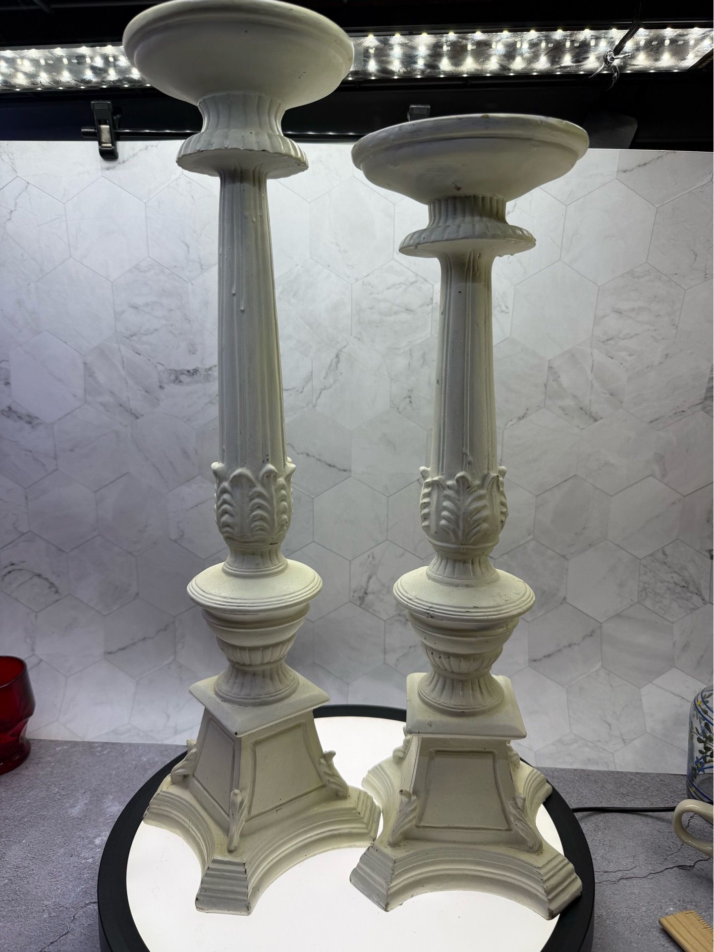 Set of (2) Vintage-style large polyrisen candlestick holders featuring a distressed off white finish. For indoor/Outdoor use. Great for photo shoots &