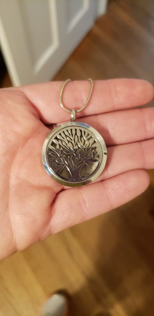 Locket With A Cut Out Tree On Front