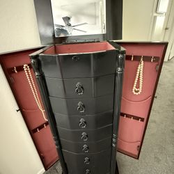 Tall Black Jewelry Box,, With 8 Drawers Top opens  For extra Storage use.  Color is black .