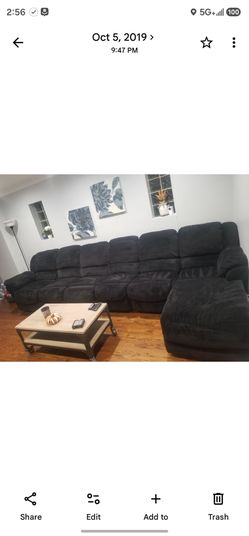 Black microfiber sectional couch with 3 manual footrests