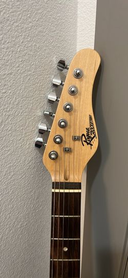 A Rouge Rocketeer 6 String Electric Guitar + 10W Amp (Bag included)