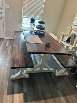 Rustic farmhouse dining table w/ benches.