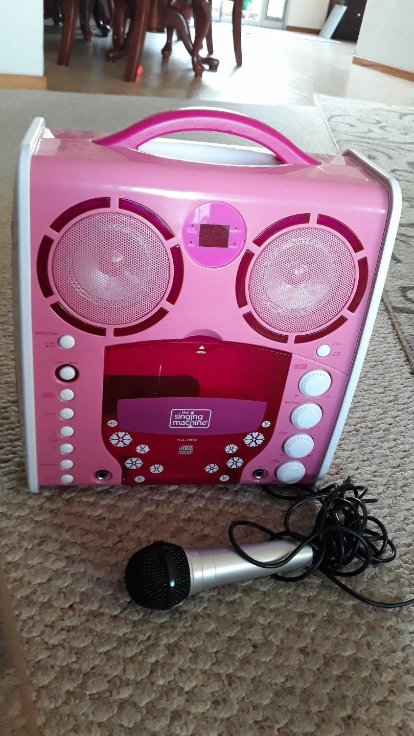 Pink karaoke machine + microphone and 2 CDs