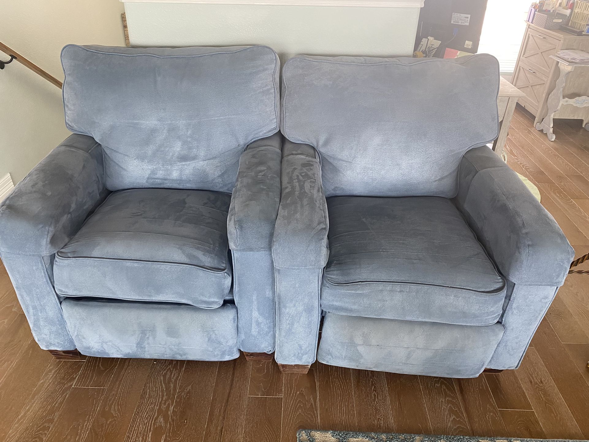 Two Blue Recliners And One Rattan Chair