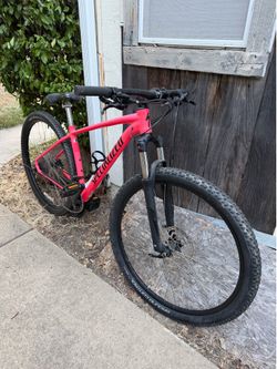 Bright pink Specialized Rockhopper Comp 29 mountain bike