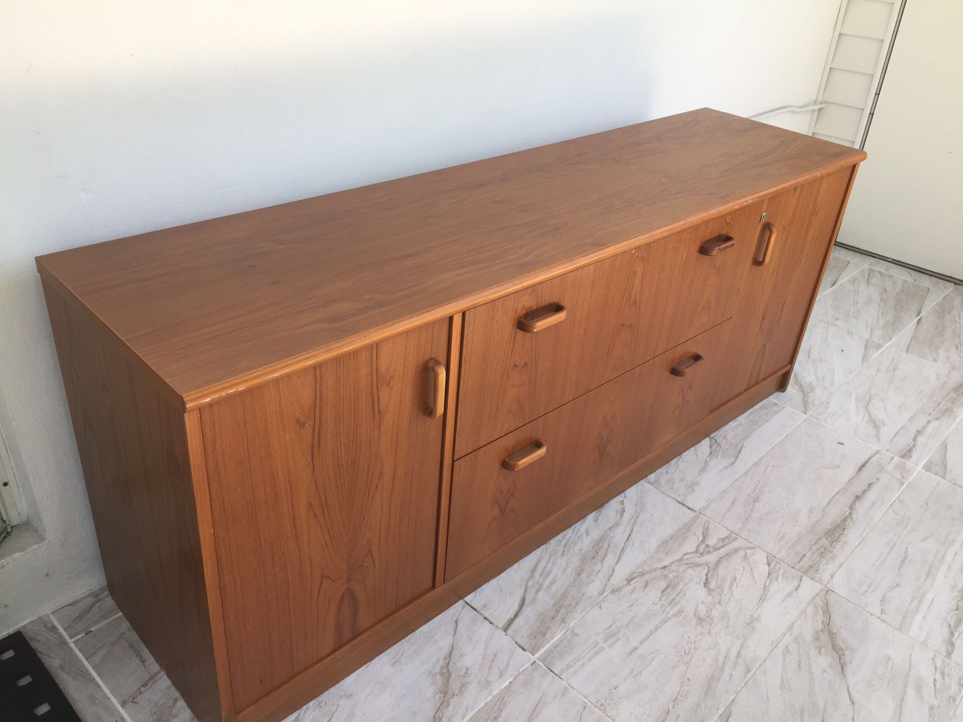 Credenza, large piece of furniture, very useful. Two deep drawers, can be used as a file cabinet. Two large side cabinets with shelves. Little damage