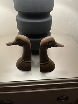 Book Ends. Solid Brass. Is Spokane are heavy. The designer is Leonard.