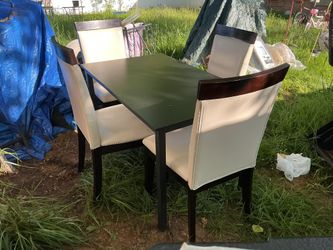 A Set Of 4 Leather Chairs With A Black Table (47” Long X 29” Wide X 29” High) The Chairs Have Some Scratchings But Not Bad