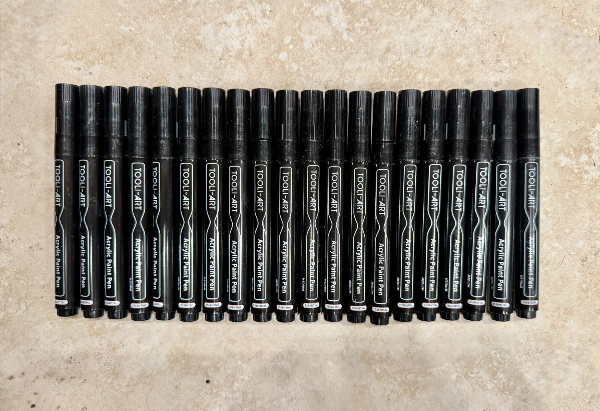 20 Tooli-Art Acrylic Paint Pen with a medium tip.