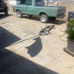 Front and rear bumpers off a 1955 Ford Fairlane.