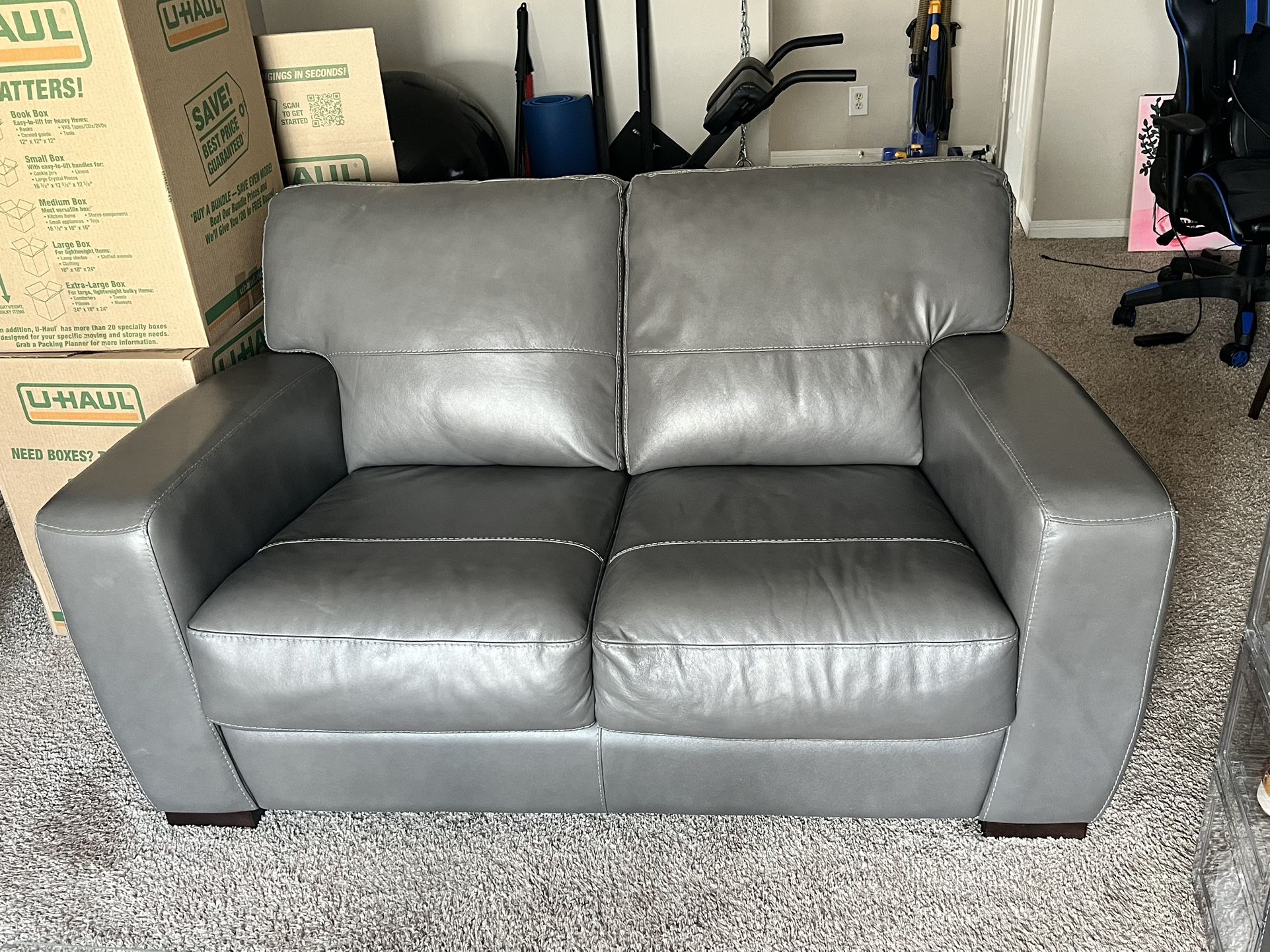 Gray Leather Couches And A Table For Sale 